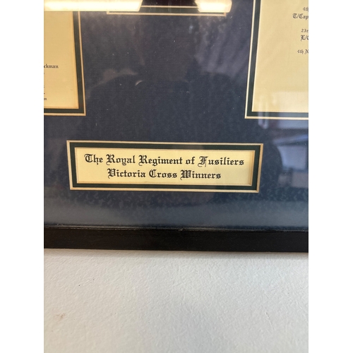 55 - Framed replica display featuring Royal Regiment VC insignia and names not postable.