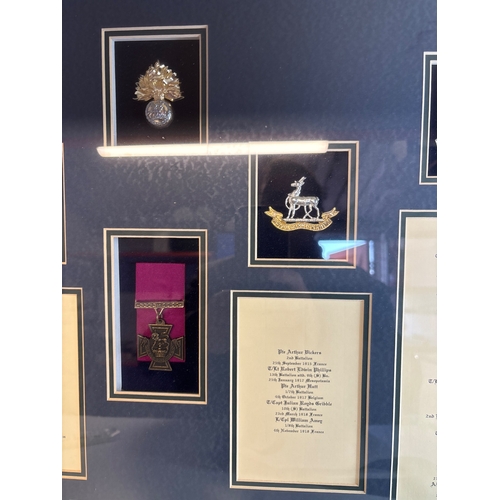 55 - Framed replica display featuring Royal Regiment VC insignia and names not postable.
