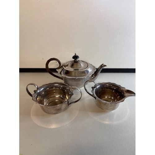 6 - Three-piece silver plated tea set including teapot, creamer, and sugar bowl.