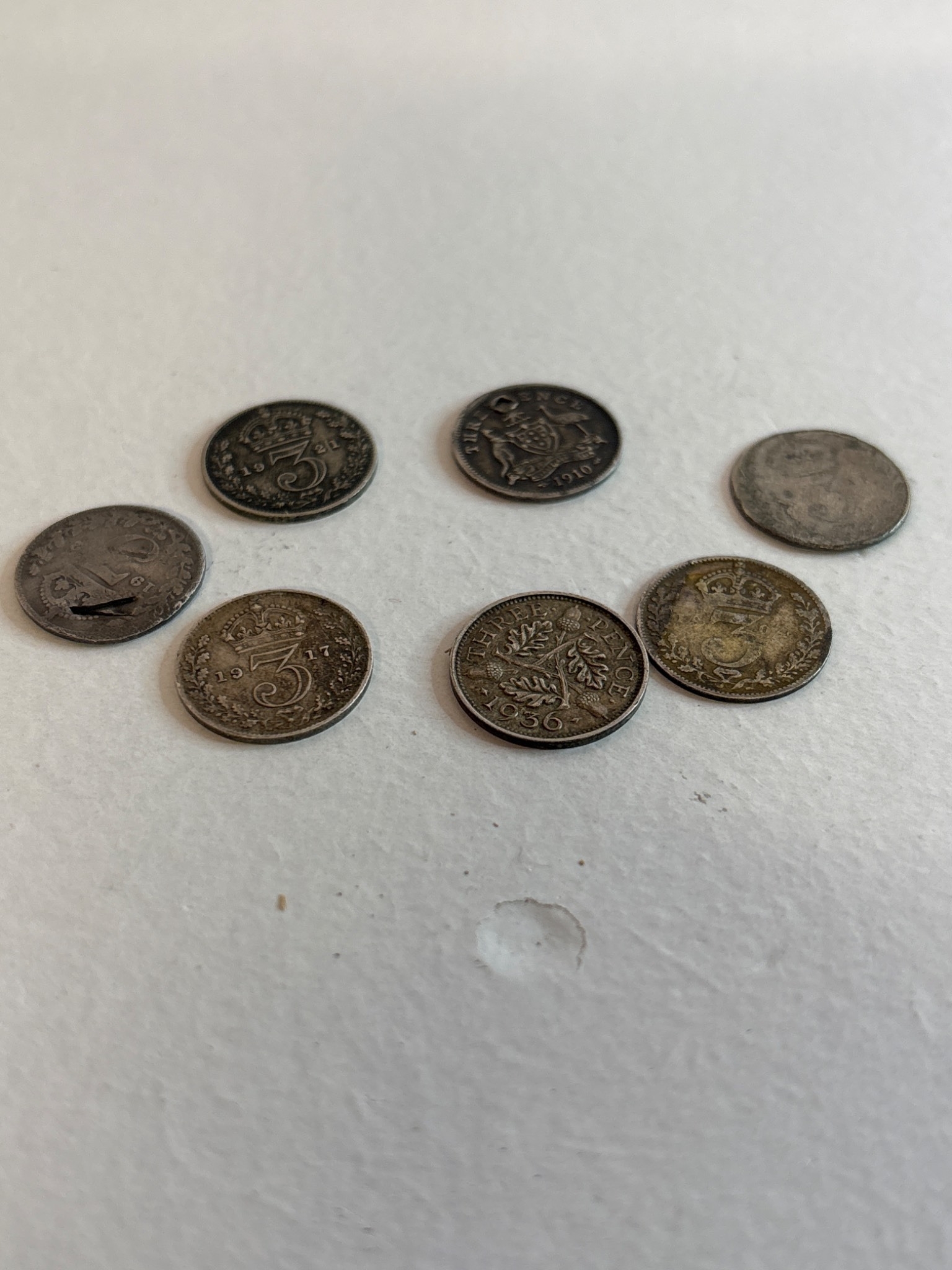 Seven silver/ hslf silver coins with varying designs and conditions.