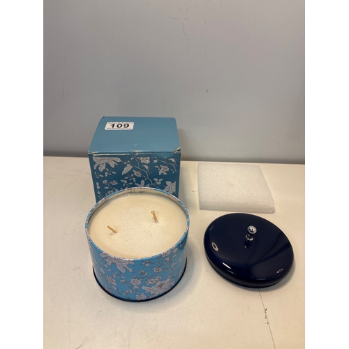 109 - Two-wick candle in decorative blue tin, includes original box.