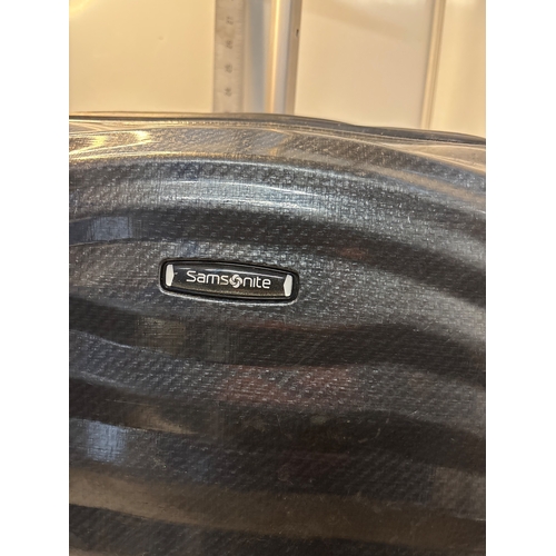 62 - Samsonite black patterned spinner luggage with wheels.