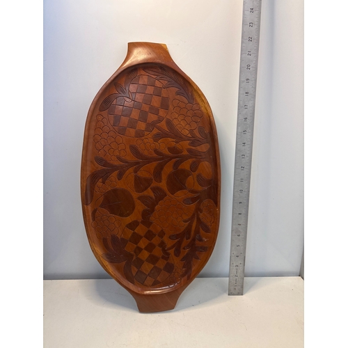 81 - Hand-carved wooden tray with floral and checkered design. Approximately 12 inches long.