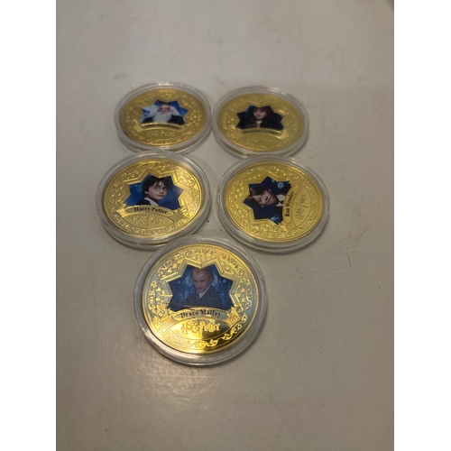 99 - Five gold-tone coins with Harry Potter characters.