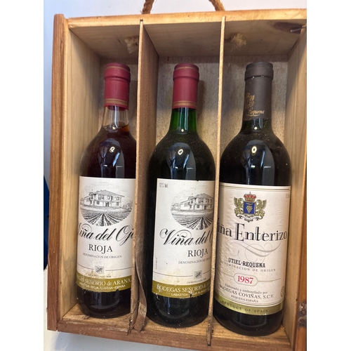 Six Rioja wines in a wooden crate.
