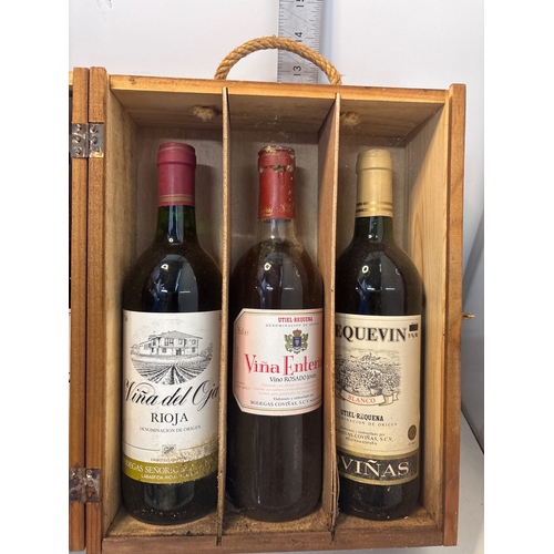 Six Rioja wines in a wooden crate.