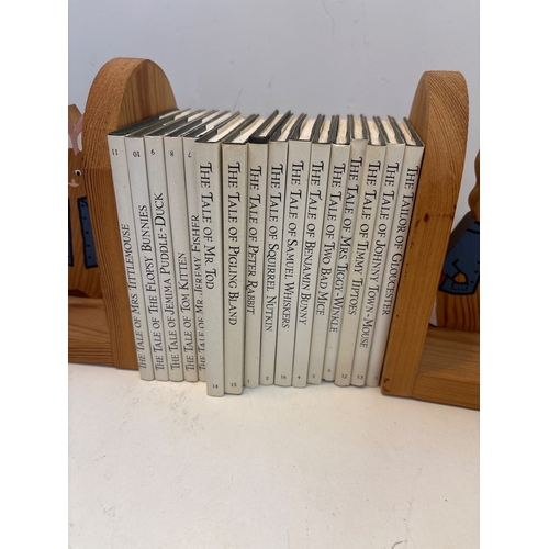 44 - Beatrix Potter books with wood bookends.