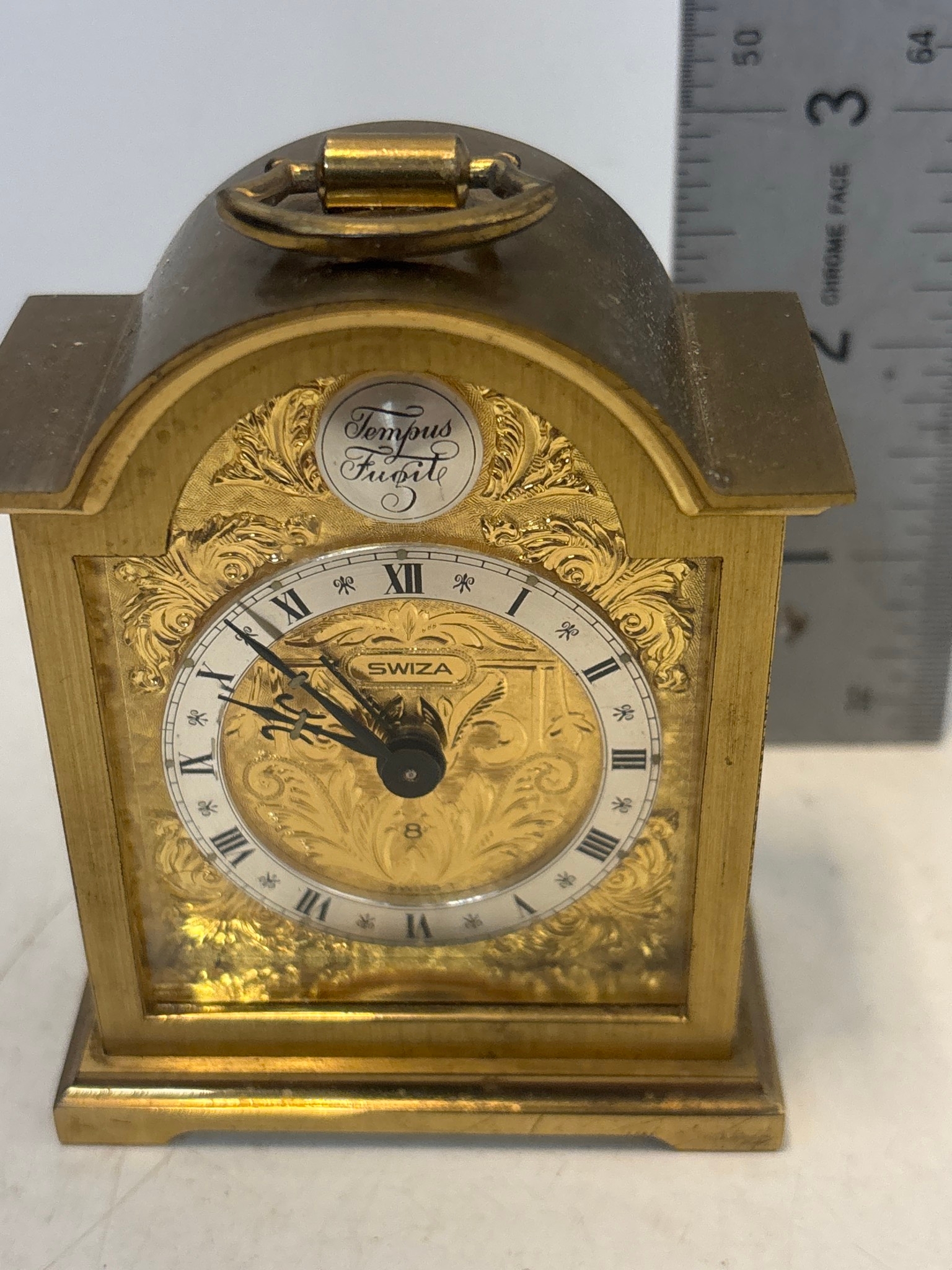 Brass desk clock by Swiza, featuring ornate engraved details and ...