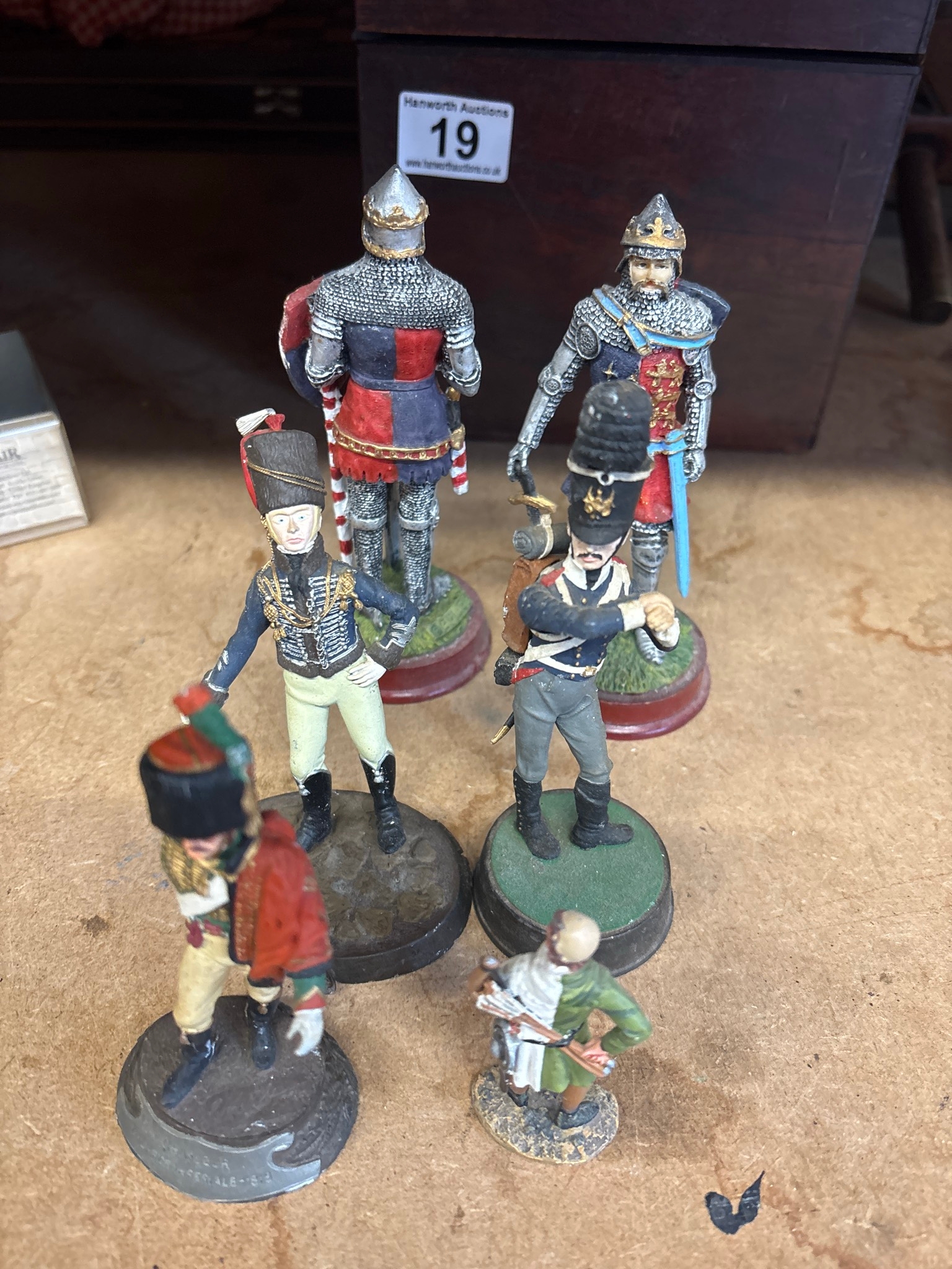 Five painted military figurines, including knights in armor and ...