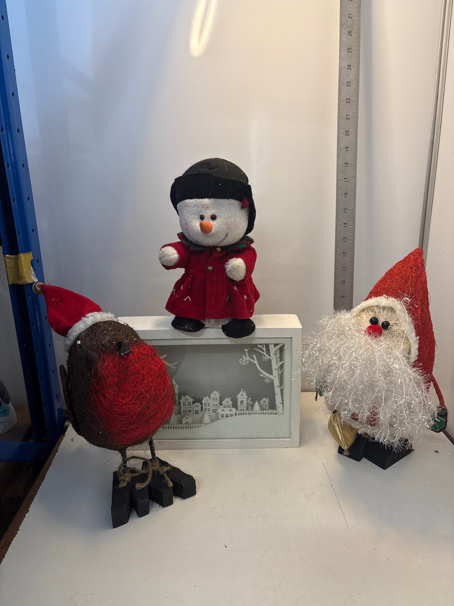 Santa figure, a snowman figure with helmet and red coat, a bird figure ...