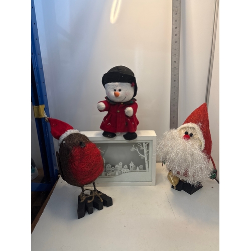 Santa figure, a snowman figure with helmet and red coat, a bird figure ...