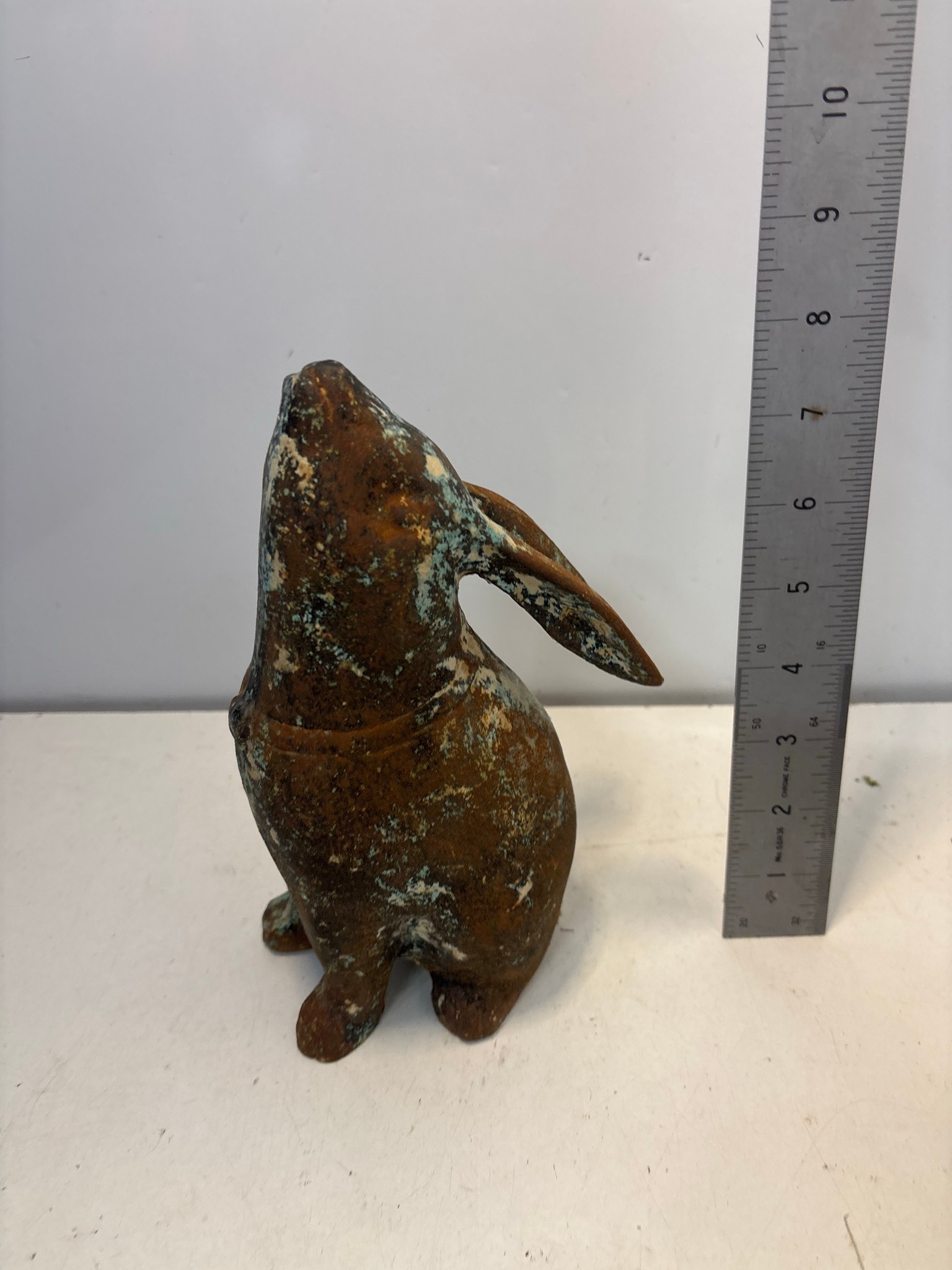 Cast iron rabbit garden statue with a weathered patina. The figure ...