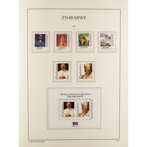 948 - ZIMBABWE 1980-2009 NEVER HINGED MINT COLLECTION in a hingeless Lighthouse album with slipcase, a com... 