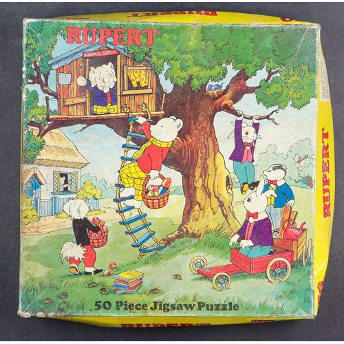 59 - RUPERT THE BEAR COLLECTOR'S BOX. A range of items which includes 1950s-1960s Adventure Series (12-24... 