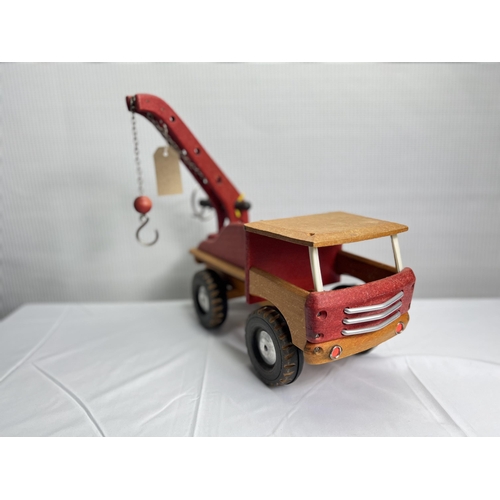 43 - A charming vintage wooden truck with a functioning crane, a perfect addition to any collection of no... 