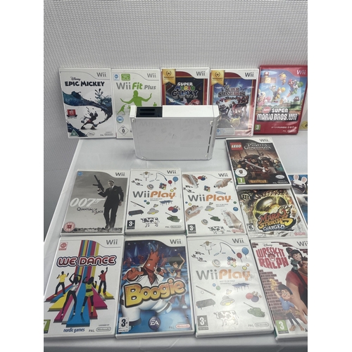 6 - A large lot of Nintendo Wii Games and Wii Console to include Boxed Mario Kart and Steering Wheel, Su... 