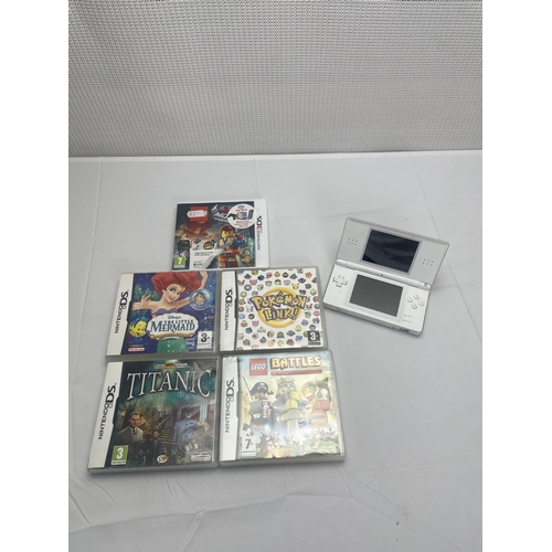 74 - White Nintendo DS and Games including Titanic, Lego Movie, Lego Battles and The little mermaid. Poke... 