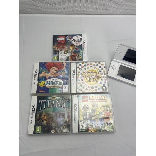 74 - White Nintendo DS and Games including Titanic, Lego Movie, Lego Battles and The little mermaid. Poke... 