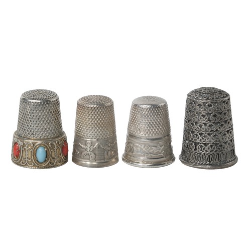 Collection of Four Unusual Thimbles:
1 - Black Niello inlay. Marked 'Jerusalem' and 'sterling' inside of dome.
2 - Punched dome with Gebruder Gabler 8-pointed star.  Ivy sprays on rim. Marked with 925, London import mark, 1974 and mark of Peter Gilmore Ltd.
3 - Marked 925. Gilt rim set with 5 different coloured stones. Small flower on dome. Various small markings above rim including '925'. Believed to be Italian.
4 - White metal - decorative band of Breton children dancing. French. Very small indistinguishable mark on top rim of band. Believed to be designed by Prudhomme c.1890-1900.