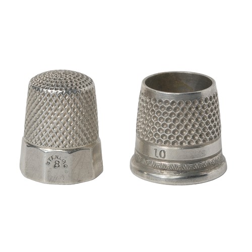 43 - Two American Thimbles:
1 - Panelled base inscribed with initials AHM.  Marked sterling. Simon Bros S... 