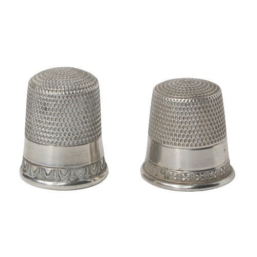 57 - Two American Simon Bros Sterling Silver Thimbles:
1 - Marked sterling. Decorated with border of aste... 