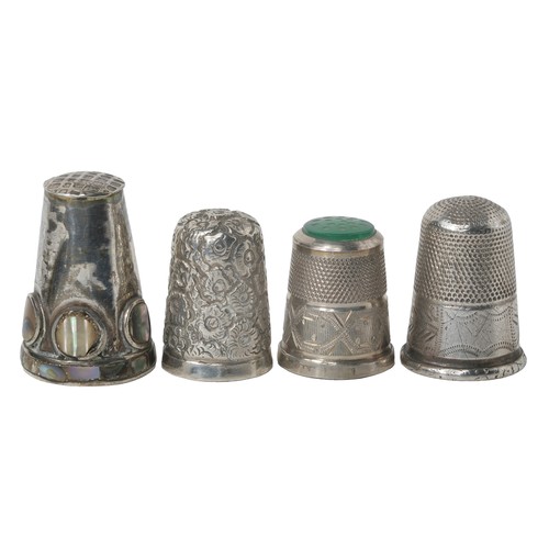 74 - Collection of Four Thimbles:
1 - Unmarked white metal. All-over floral design.
2 - Possibly Mexican ... 