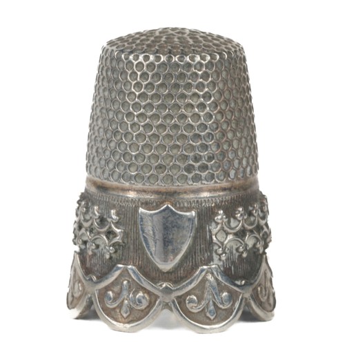 77 - Decorative scalloped edged white metal thimble. Decorative border.  Small plain shield on one side. ... 