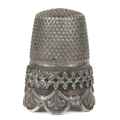 77 - Decorative scalloped edged white metal thimble. Decorative border.  Small plain shield on one side. ... 