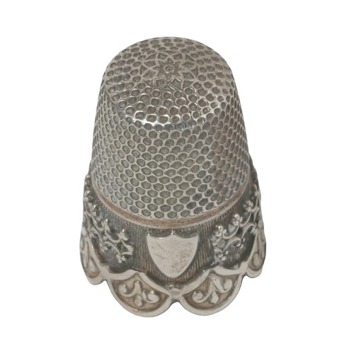 77 - Decorative scalloped edged white metal thimble. Decorative border.  Small plain shield on one side. ... 