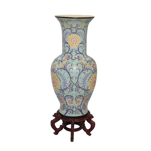 51 - Large Oriental Decorative Vase on Wooden Base. Pale blue with dark blue, pink and yellow floral patt... 