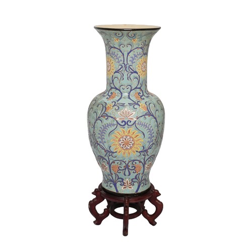 51 - Large Oriental Decorative Vase on Wooden Base. Pale blue with dark blue, pink and yellow floral patt... 