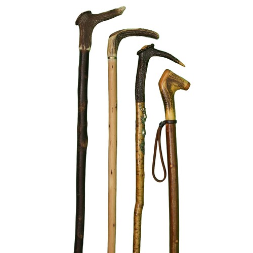 78 - Collection of 4 Stag Horn Walking Sticks, 1 with whistle handle. 1 has 5 UK badges. 
Measurements ar... 