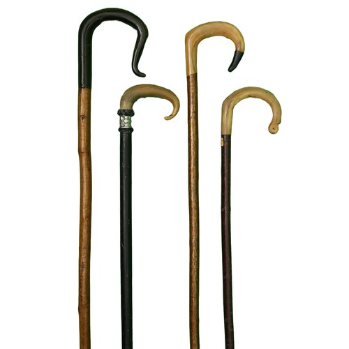 93 - Collection of 4 Sheep's Horn Walking Sticks. Includes:
1 x Dark wood stick with light horn handle. A... 