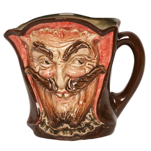 A Small Royal Doulton 'Mephistopheles' character jug, the base bearing the verse 'When the devil was sick, the devil a saint would be, when the devil got well, devil a saint was he'. 8cm high with printed mark.