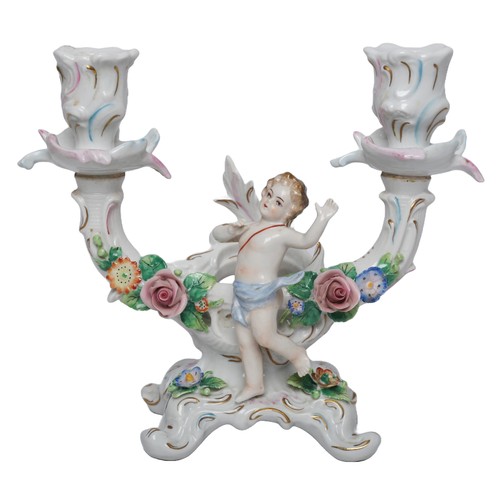 108 - A pair of Sitzendorf porcelain candlesticks , each with two branches moulded with a cherub and flora... 