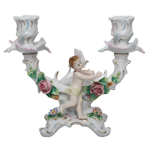 108 - A pair of Sitzendorf porcelain candlesticks , each with two branches moulded with a cherub and flora... 