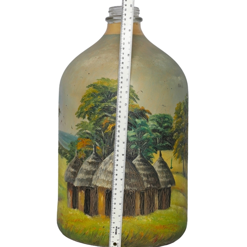 141 - Large Hand Painted Demijohn Depicting Scene of Landscape and Huts. Approx 50cm in height.