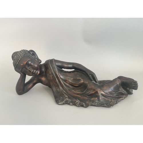 31 - A Resin Reclining Buddha Figure with Dark Bronze-Tone Finish. A resin figure of a reclining Buddha,i... 