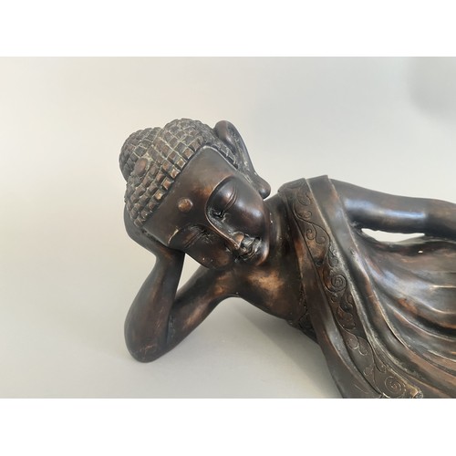 31 - A Resin Reclining Buddha Figure with Dark Bronze-Tone Finish. A resin figure of a reclining Buddha,i... 