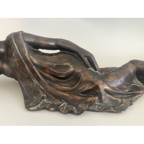 31 - A Resin Reclining Buddha Figure with Dark Bronze-Tone Finish. A resin figure of a reclining Buddha,i... 