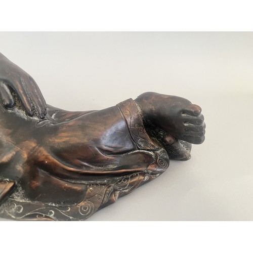31 - A Resin Reclining Buddha Figure with Dark Bronze-Tone Finish. A resin figure of a reclining Buddha,i... 