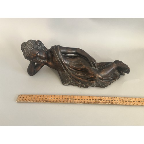 31 - A Resin Reclining Buddha Figure with Dark Bronze-Tone Finish. A resin figure of a reclining Buddha,i... 