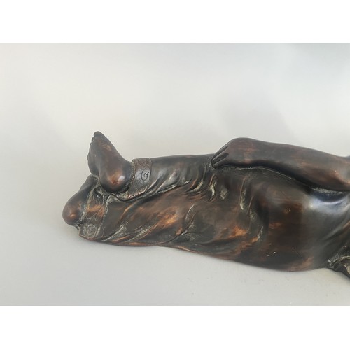 31 - A Resin Reclining Buddha Figure with Dark Bronze-Tone Finish. A resin figure of a reclining Buddha,i... 