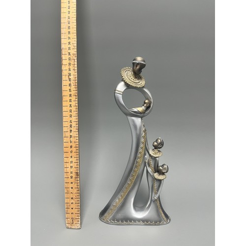 3 - Stylized Silver and Gold African Mother and Children Figurine.
A single silver- and gold-toned figur... 