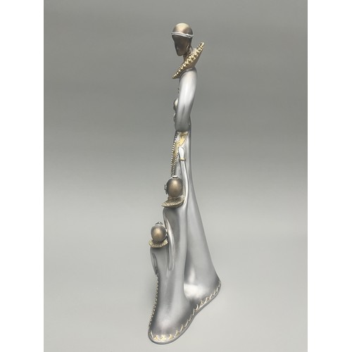 3 - Stylized Silver and Gold African Mother and Children Figurine.
A single silver- and gold-toned figur... 