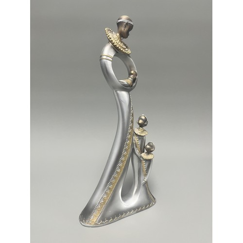 3 - Stylized Silver and Gold African Mother and Children Figurine.
A single silver- and gold-toned figur... 