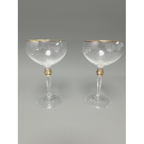 4 - A Pair of Crystal Clear Sara Gold Stem Wine Glasses. A pair of clear crystal wine glasses, likely Sa... 