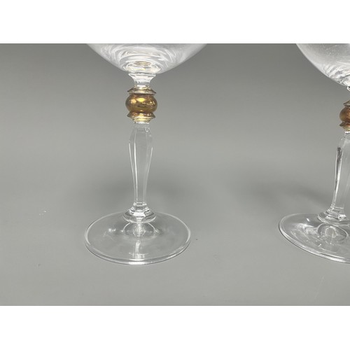 4 - A Pair of Crystal Clear Sara Gold Stem Wine Glasses. A pair of clear crystal wine glasses, likely Sa... 