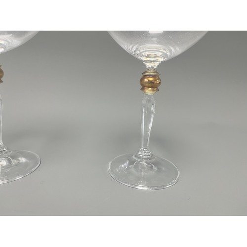 4 - A Pair of Crystal Clear Sara Gold Stem Wine Glasses. A pair of clear crystal wine glasses, likely Sa... 