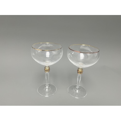 4 - A Pair of Crystal Clear Sara Gold Stem Wine Glasses. A pair of clear crystal wine glasses, likely Sa... 